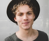 man standing near white wall